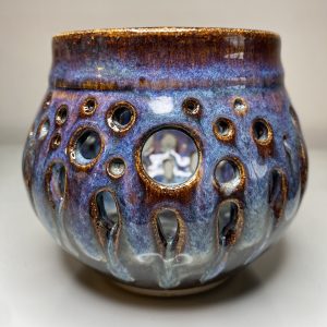 spherical hand thrown pot with hole for a tea light. Representing bubbles. Glossy blues and purples